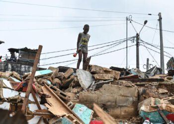 A child is seen among rubbles of the district of Attecoube in Abidjan, after the demolition of several houses on March 1, 2024. The governor of the distrit of Abidjan begun an operation to demolish high-risk neighborhoods in Abidjan. (Photo by Issouf SANOGO / AFP)