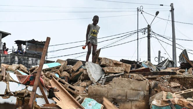 A child is seen among rubbles of the district of Attecoube in Abidjan, after the demolition of several houses on March 1, 2024. The governor of the distrit of Abidjan begun an operation to demolish high-risk neighborhoods in Abidjan. (Photo by Issouf SANOGO / AFP)